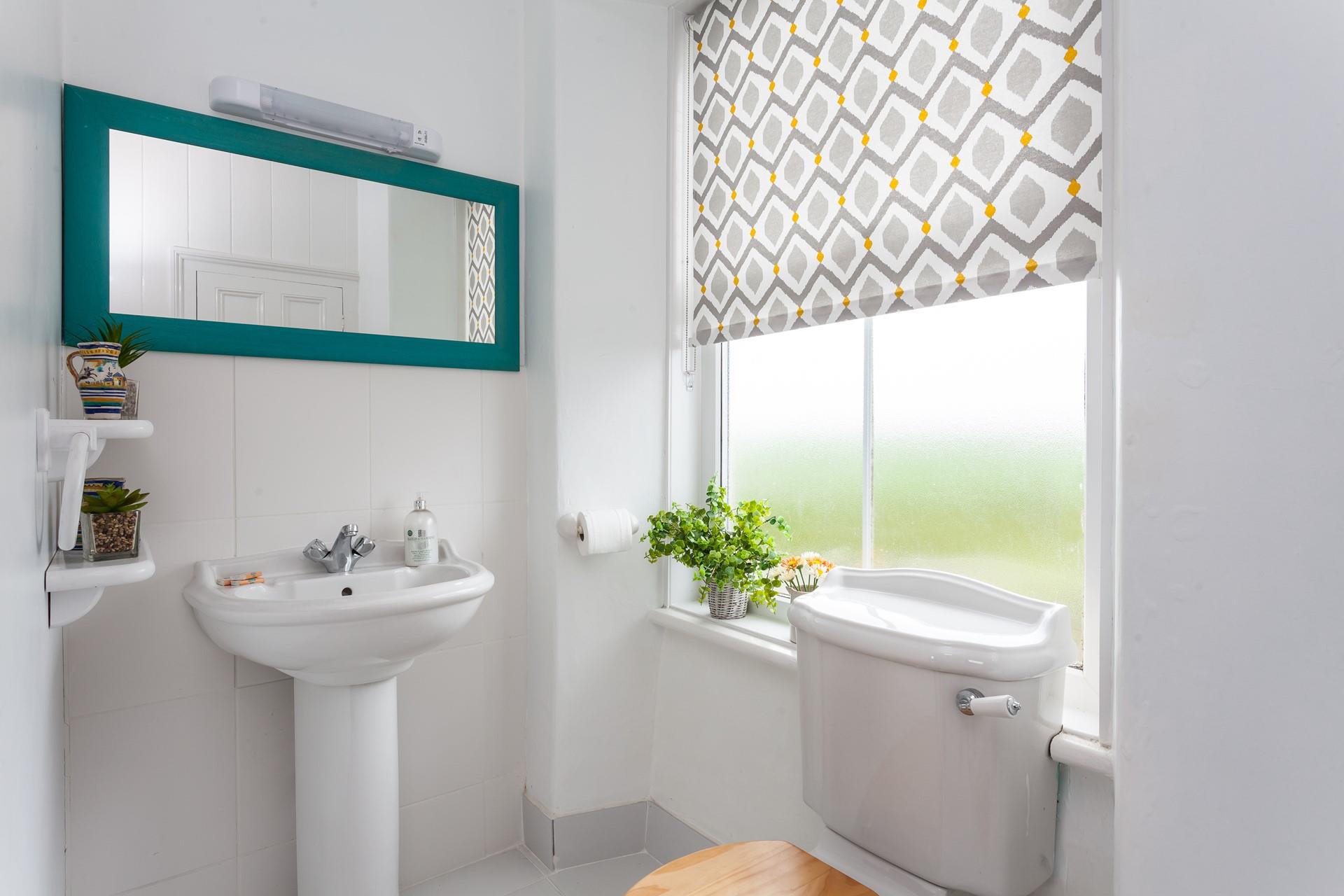 The cloakroom has a WC and a wash basin.