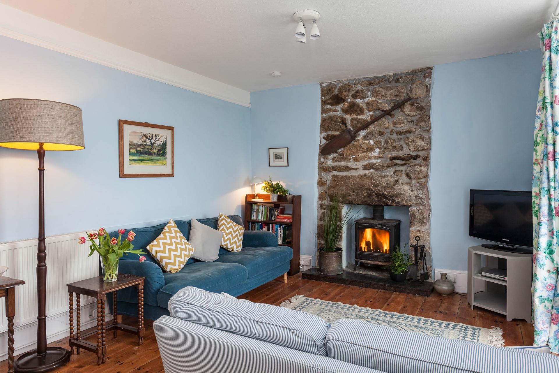 After a wintry walk on Porthcurno beach, light the woodburner and cosy up in the living room.