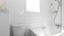 Rinse salty hair and sandy feet in the bright bathroom. 