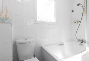 Rinse salty hair and sandy feet in the bright bathroom. 