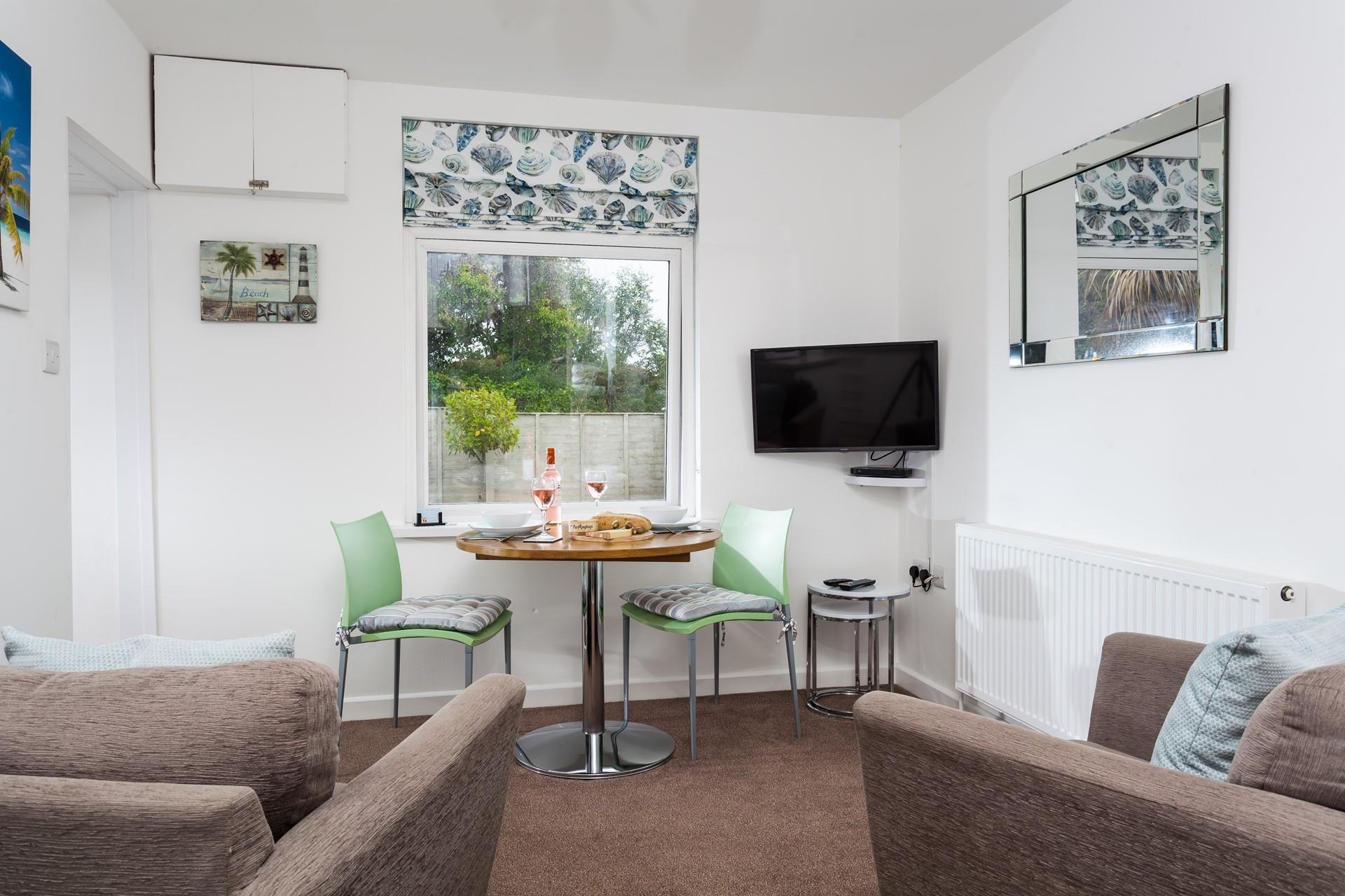 The living area is decorated with subtle seaside decor.