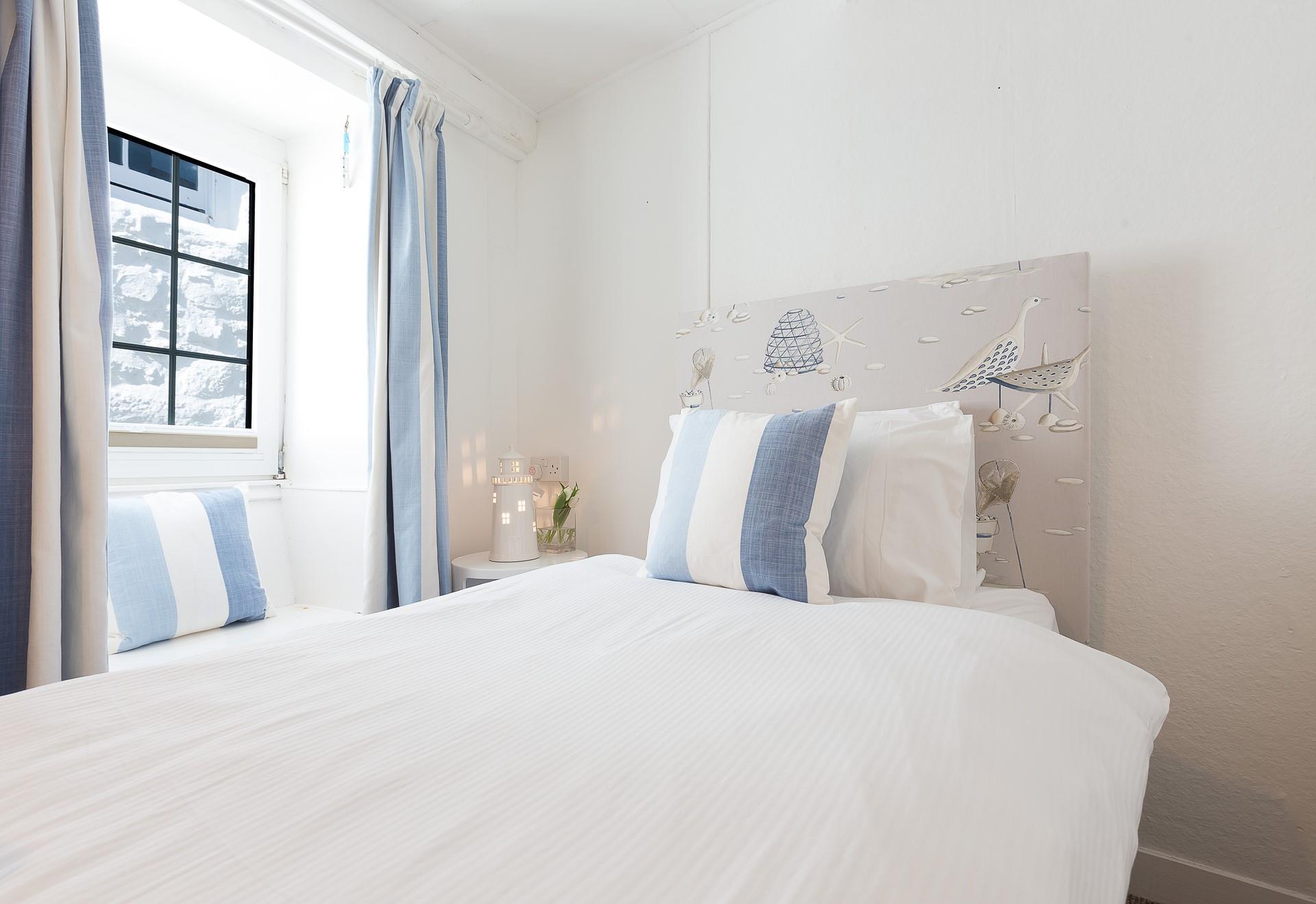 Calming blue tones fill bedroom 2.