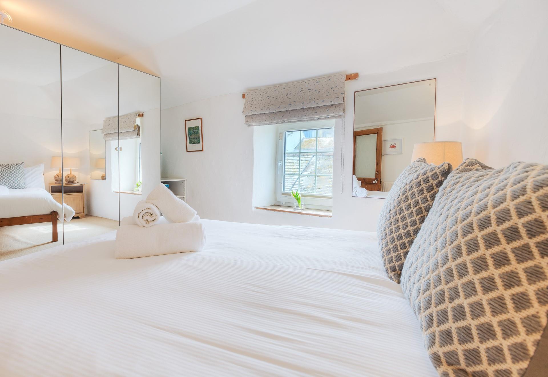 Soft sheets and fluffy towels greet you in the bedroom.