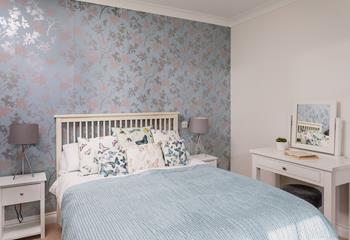 Light and airy, this beautiful bedroom also has a modern ensuite shower room. 