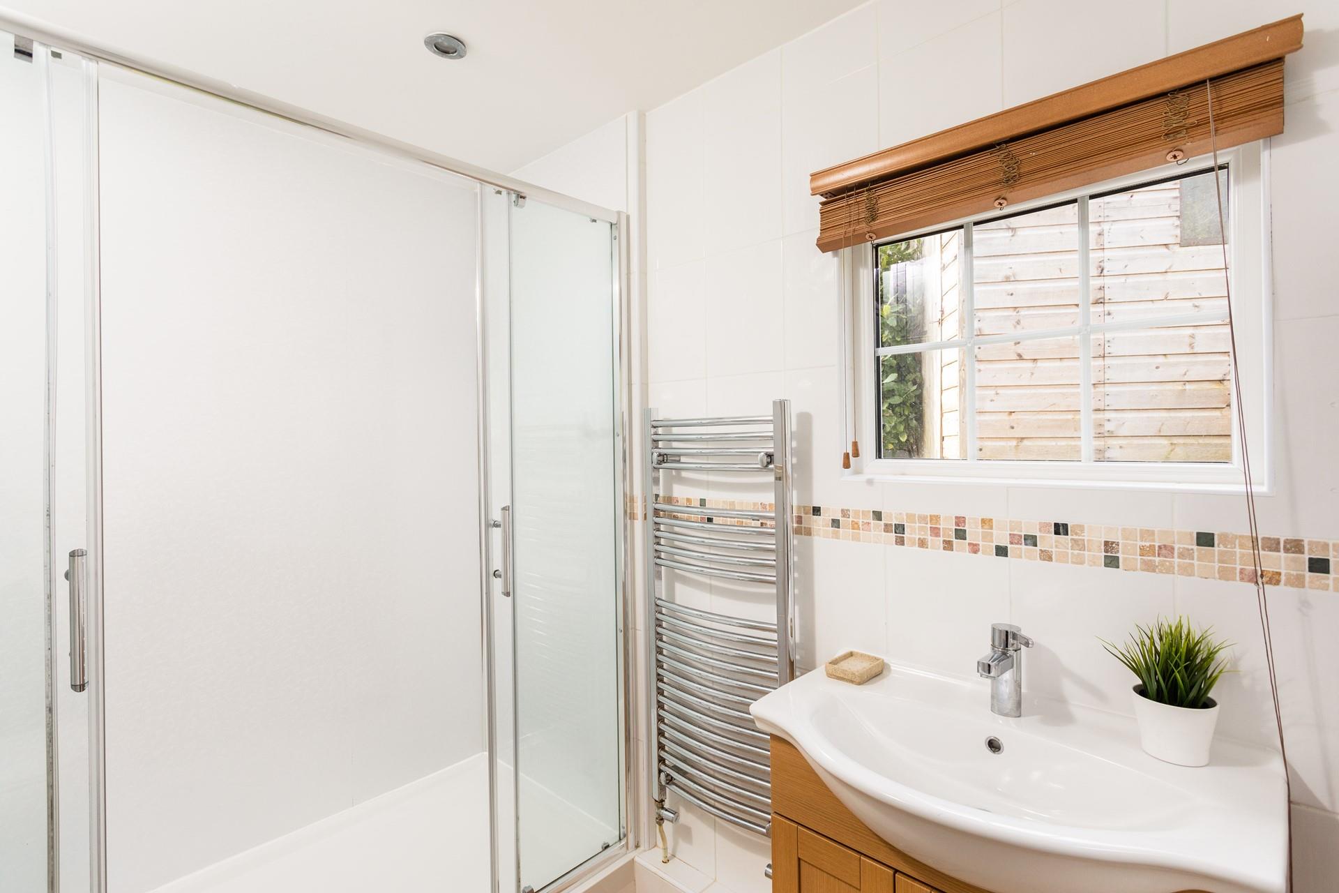 Bright and beautifully finished, the en suite shower room adds privacy and convenience for guests. 