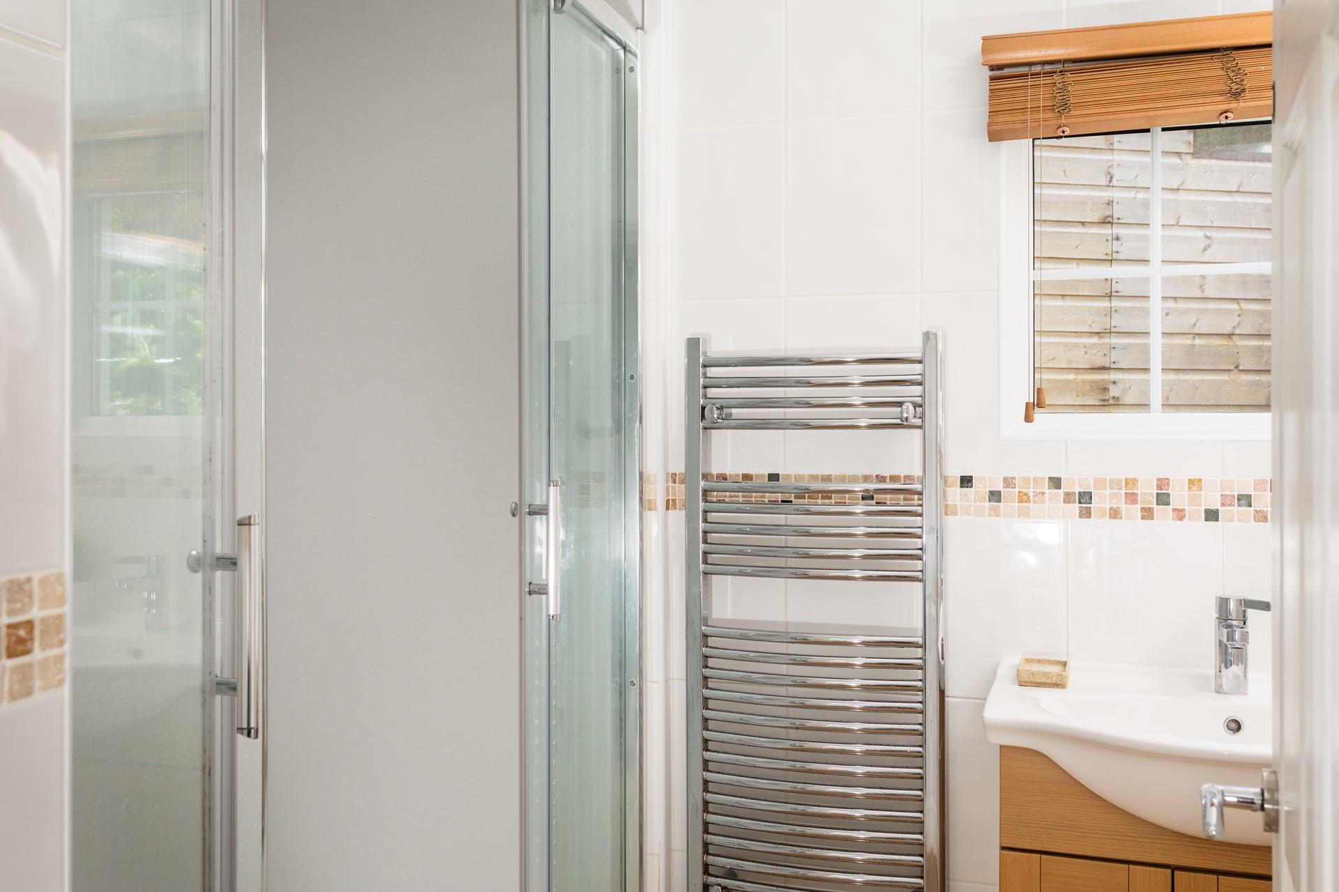 The en suite benefits from a heated towel rail so you can enjoy the added luxury of warm towels. 