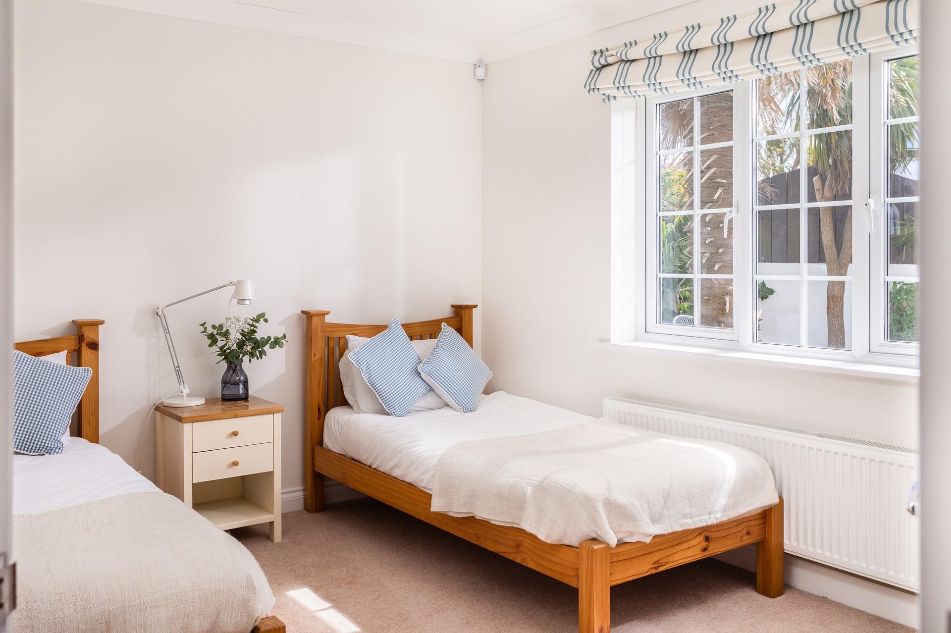 Bright and spacious, the twin room has a beautiful leafy view through the large window. 