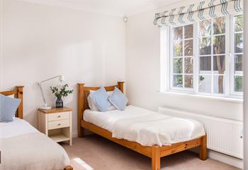 Bright and spacious, the twin room has a beautiful leafy view through the large window. 