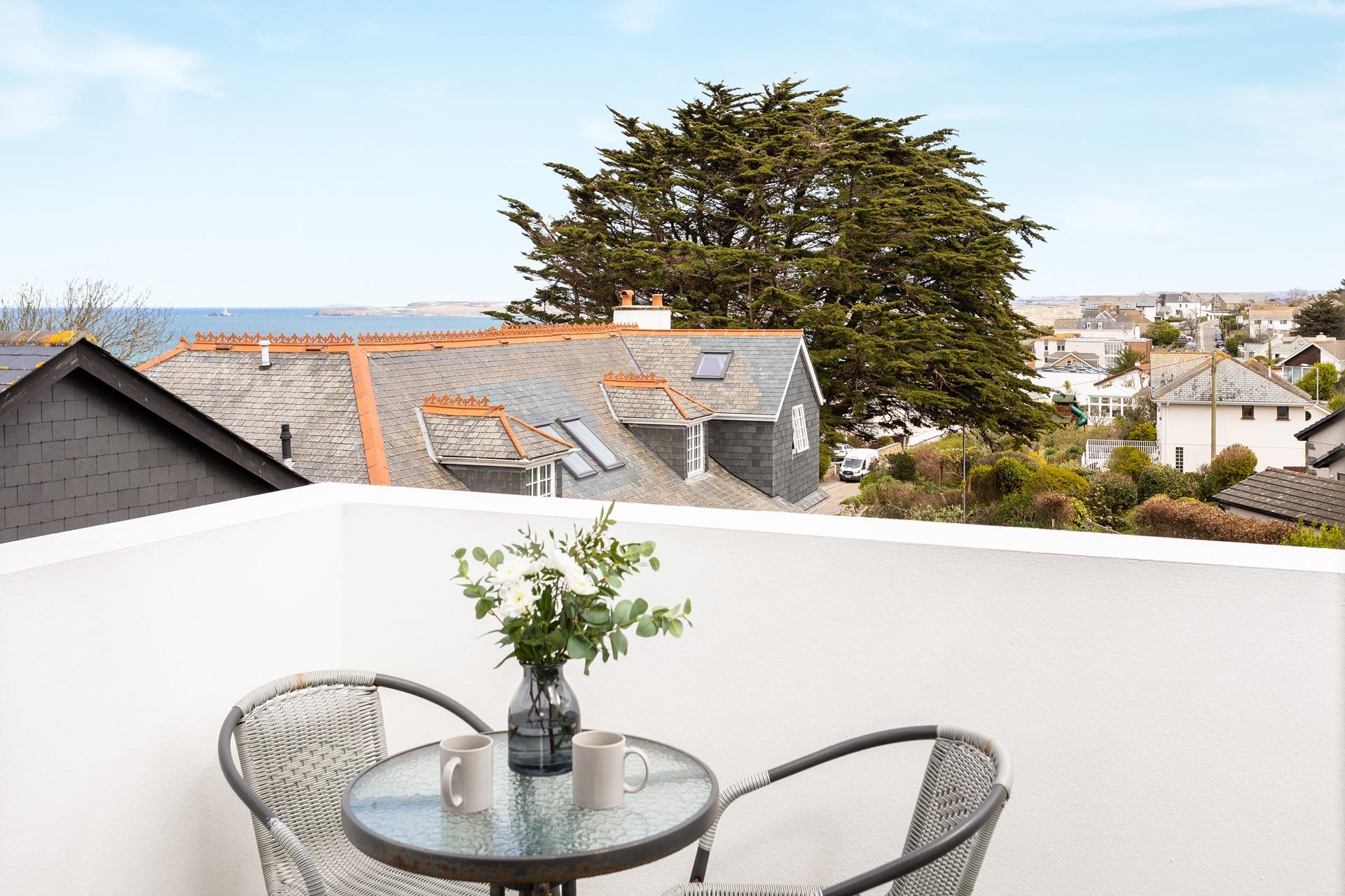 The private balcony overlooks the pretty urban area and has a sea view across Carbis bay.