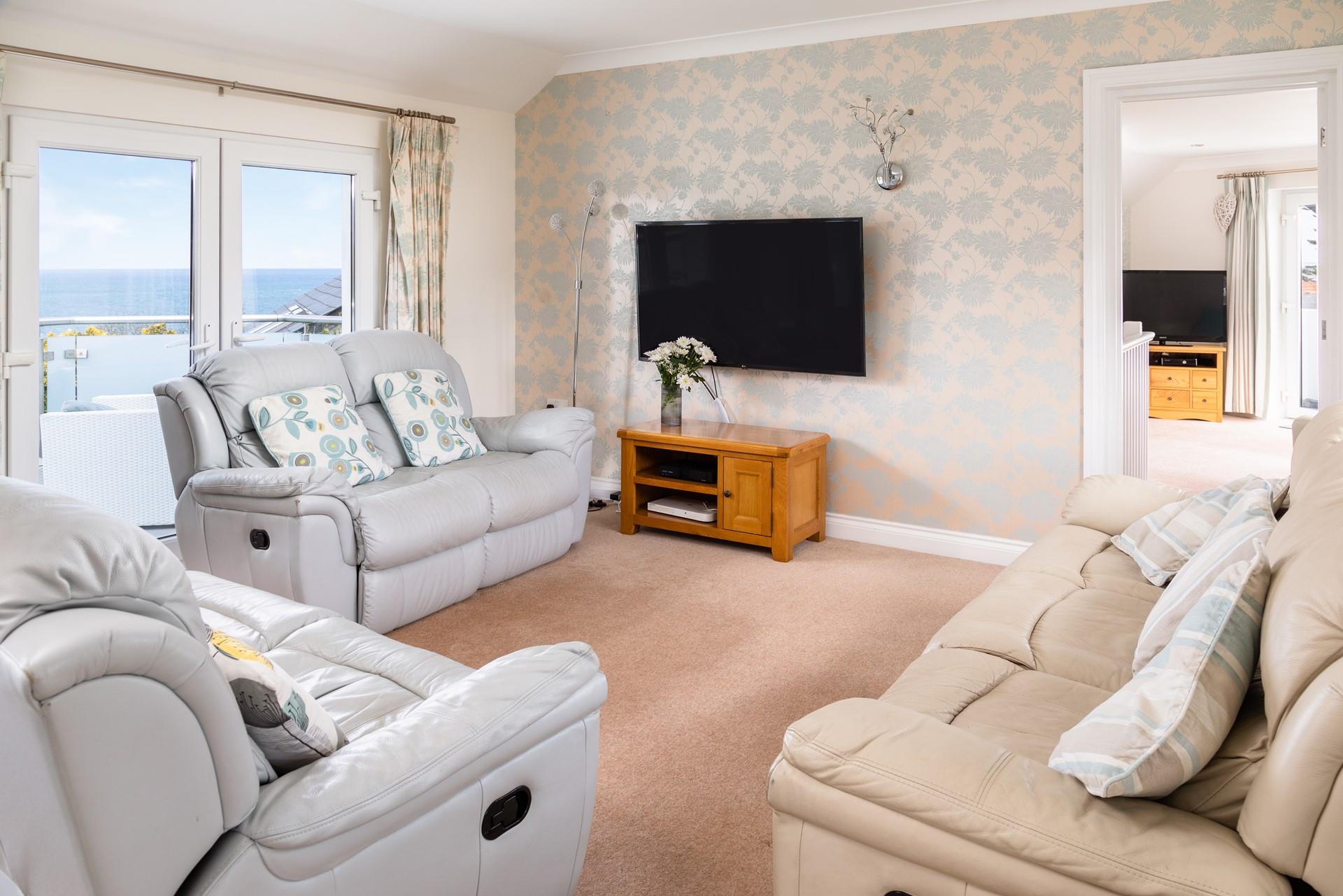 Pastel blues and creams create a calming coastal vibe in the sitting room. 