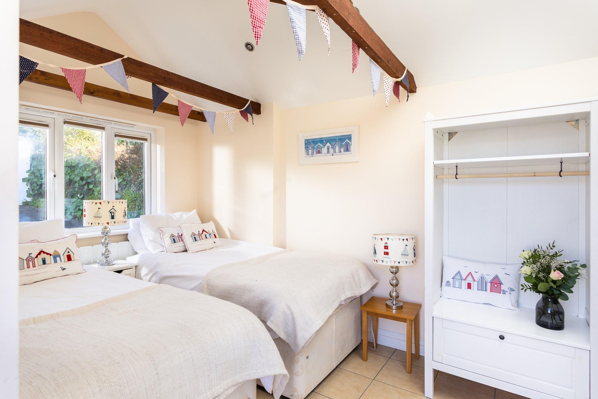The exposed beams and high ceiling add character to the annex bedroom.