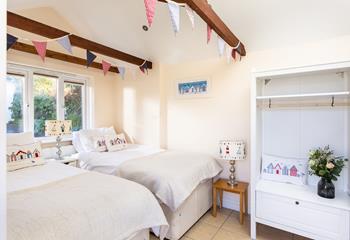 The exposed beams and high ceiling add character to the annex bedroom.