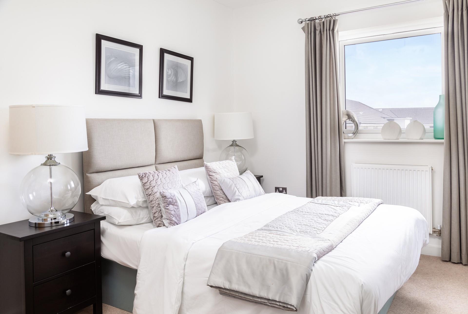 The bedroom's neutral tones promise to help you relax and drift off to sleep.