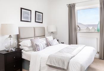The bedroom's neutral tones promise to help you relax and drift off to sleep.