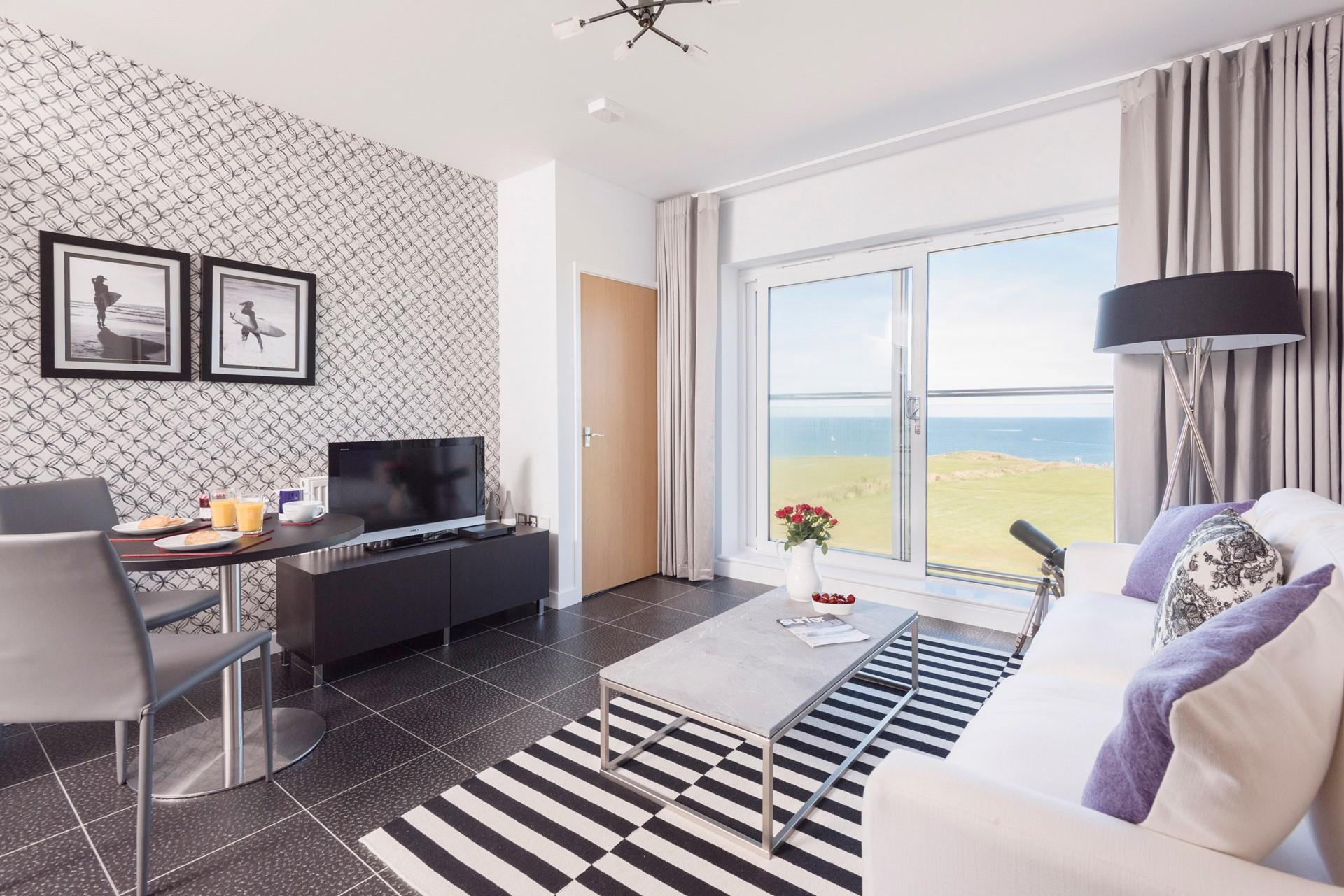 On the third floor, Atlantic Vista is a modern apartment with views from the Juliet balcony across the north coast. 
