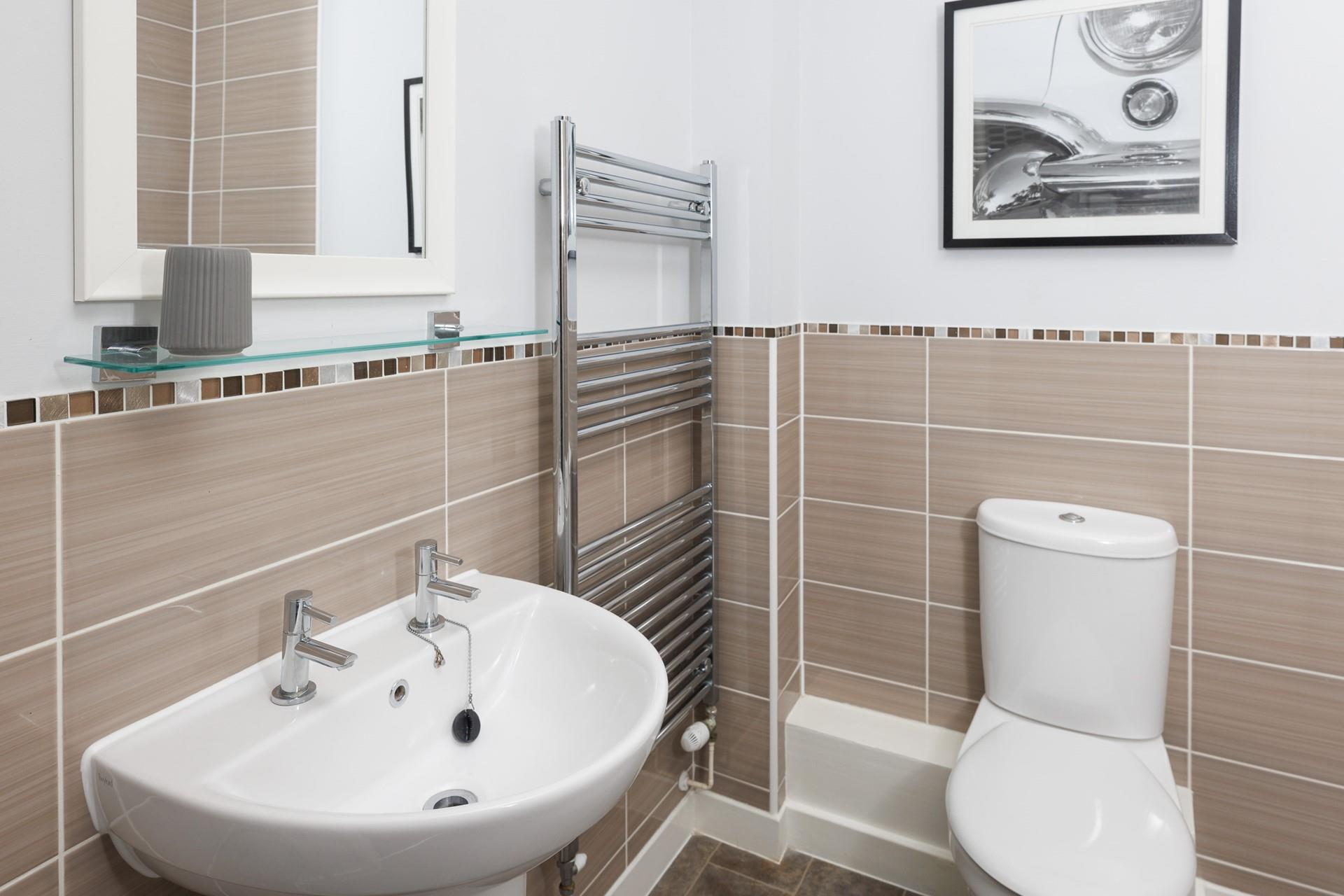 Modern with spa-like feel, the bathroom also has a heated towel rail.