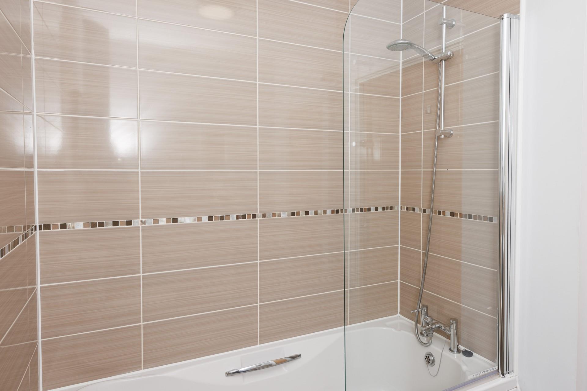 The bathroom benefits from both a shower and bath!