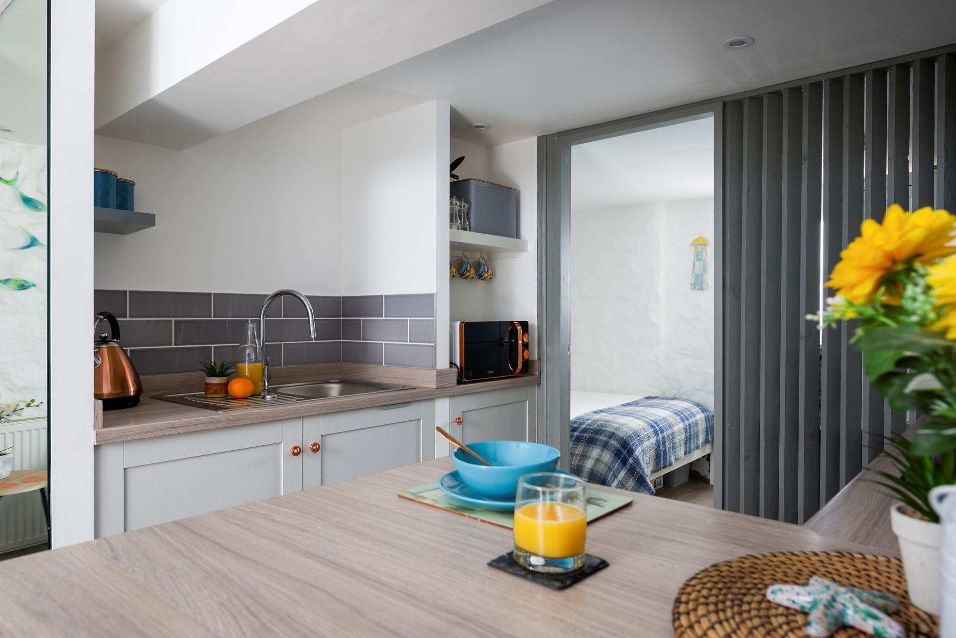 Though compact, the kitchen has everything you need to whip up delicious meals.