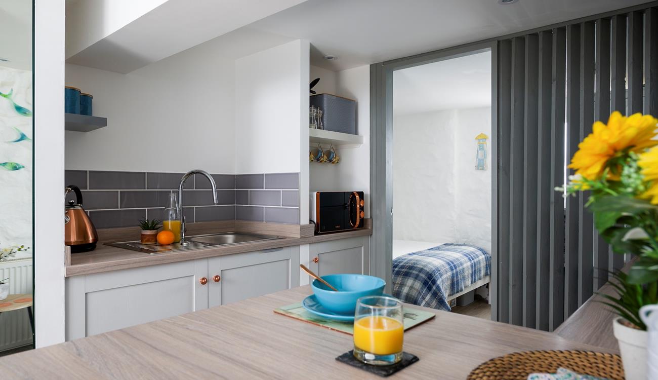 Though compact, the kitchen has everything you need to whip up delicious meals.