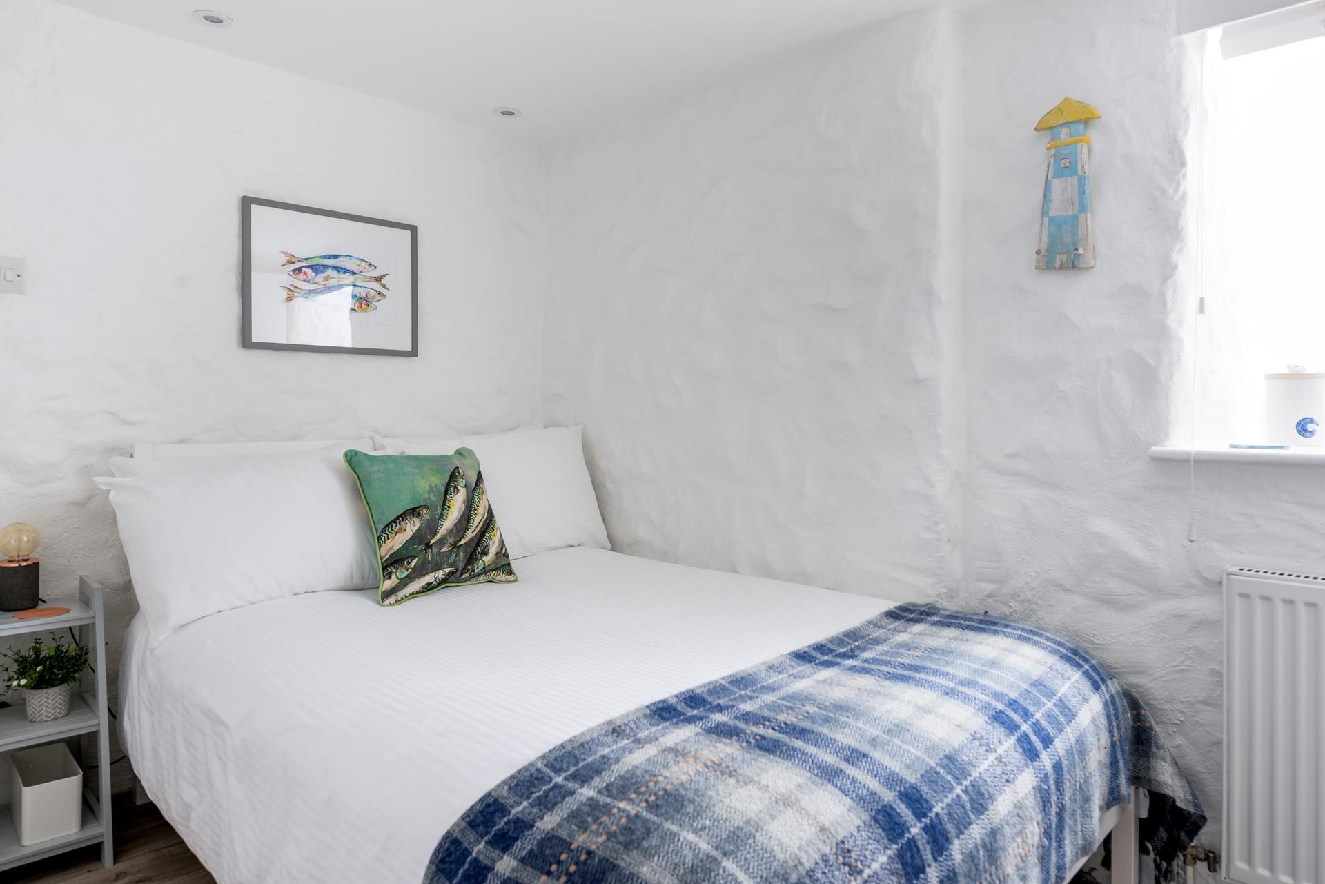 The painted stone walls give the bedroom a quaint, cottage-like feel.