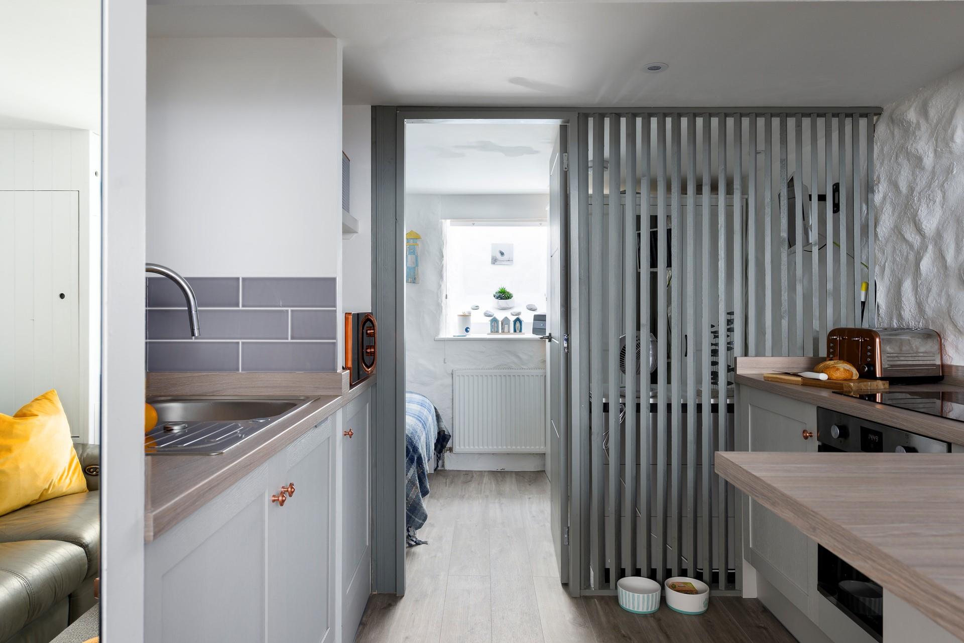 The semi-open wall allows light to stream through the entire studio apartment. 