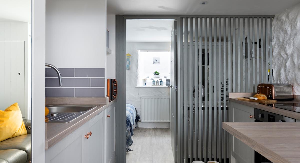 The semi-open wall allows light to stream through the entire studio apartment. 