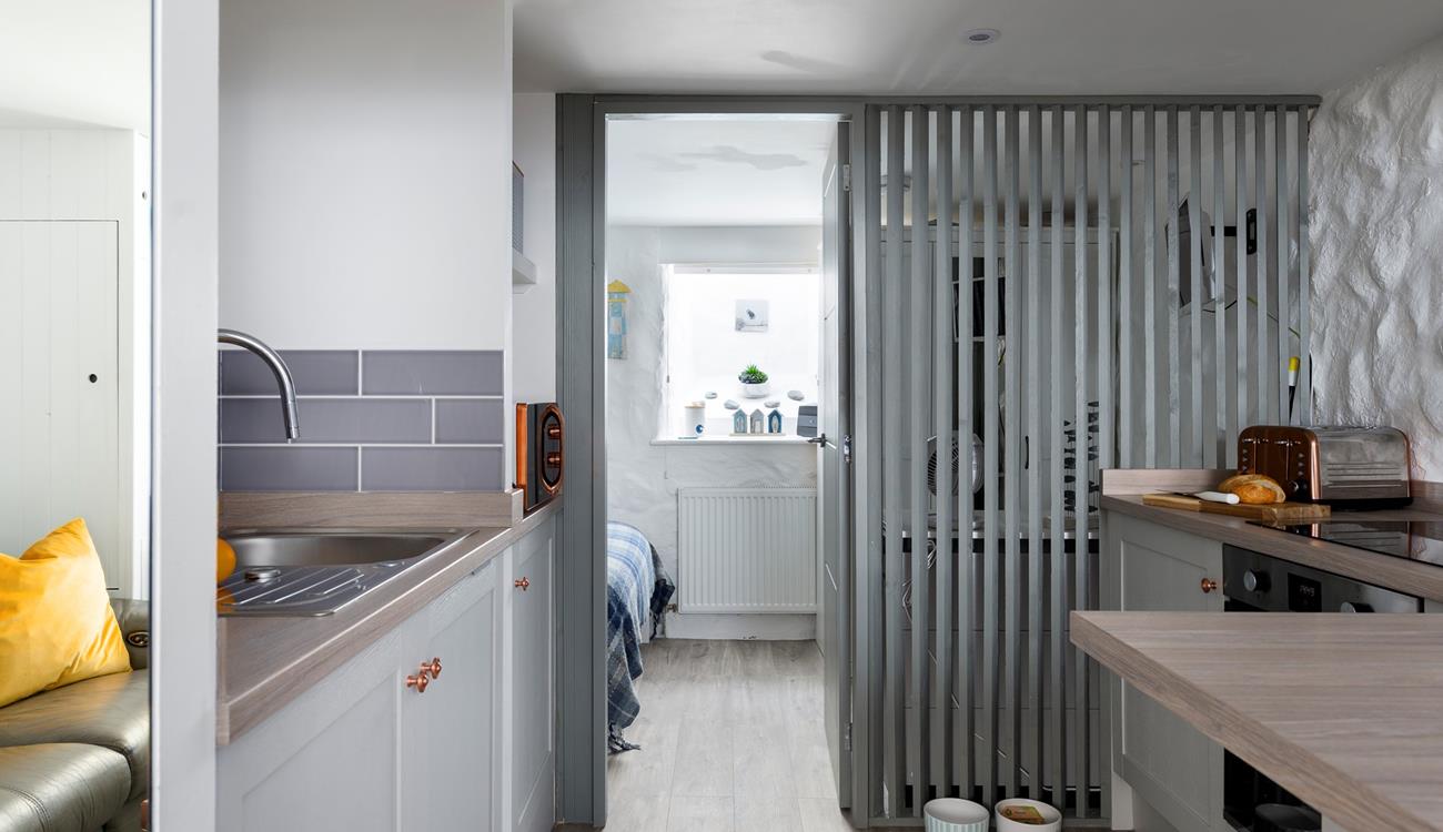 The semi-open wall allows light to stream through the entire studio apartment. 