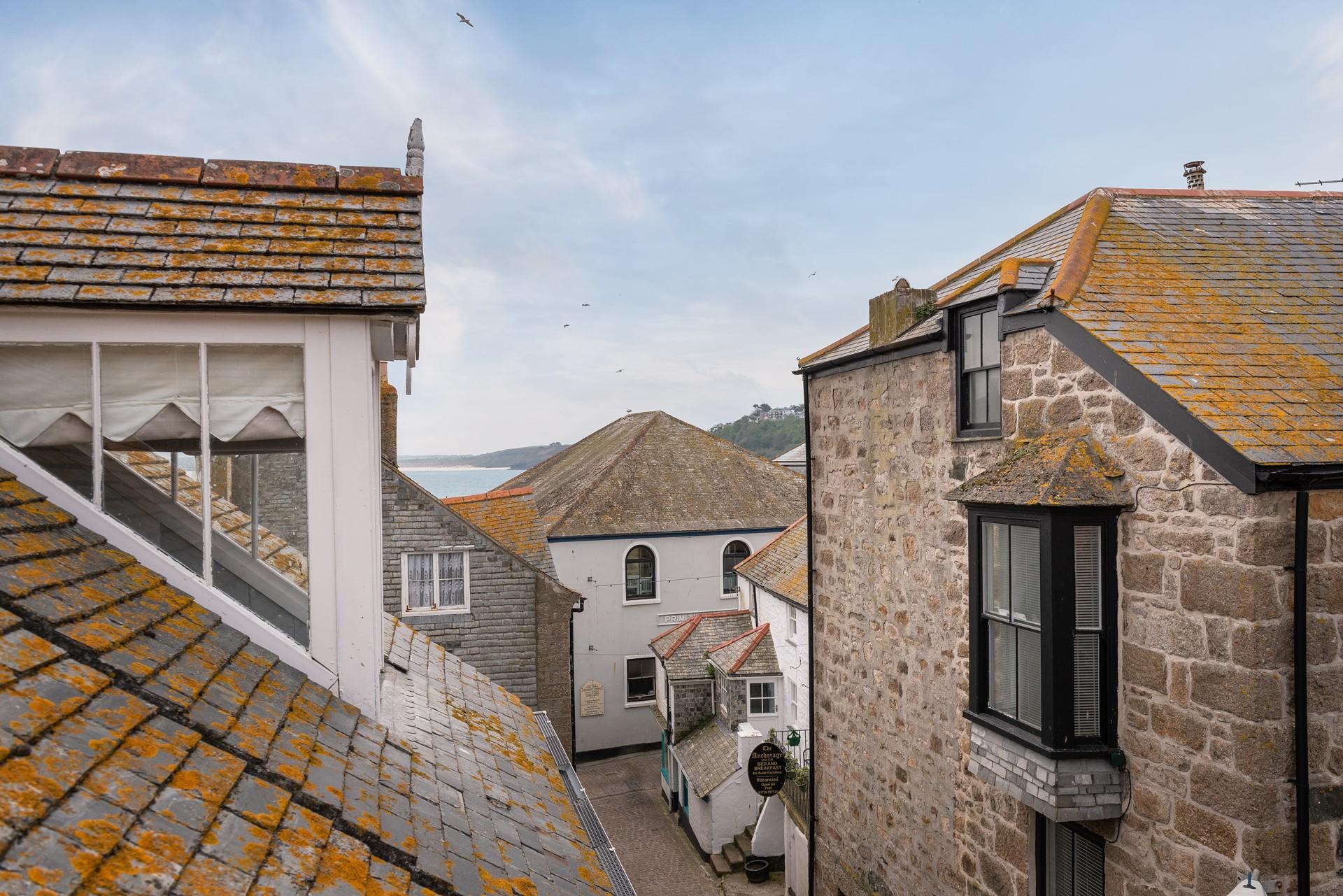 The fabulous windows allow you to look out over the incredible rooftops of St Ives to the sea glittering in the distance. 