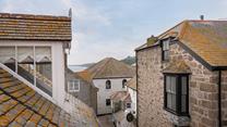 The fabulous windows allow you to look out over the incredible rooftops of St Ives to the sea glittering in the distance. 