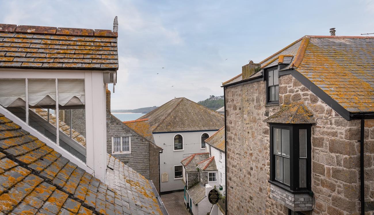 The fabulous windows allow you to look out over the incredible rooftops of St Ives to the sea glittering in the distance. 
