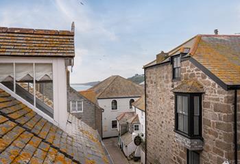 The fabulous windows allow you to look out over the incredible rooftops of St Ives to the sea glittering in the distance. 