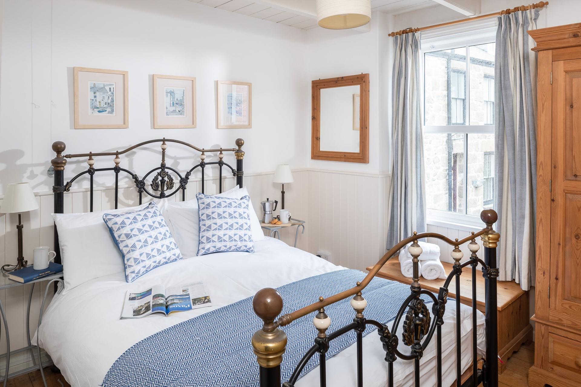 Classic furniture and a striking bed frame add a touch of luxury to the main bedroom.