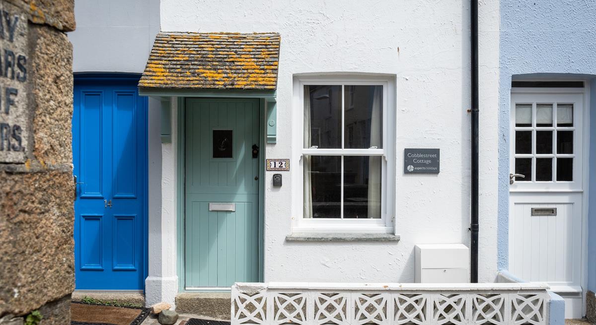 The pretty door and slate sign make the property easy to spot.