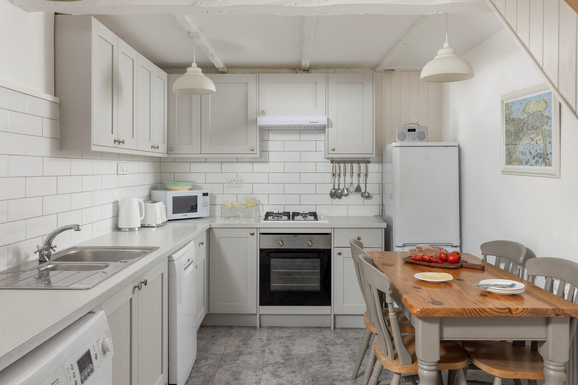 The kitchen has all you need for a relaxing stay.