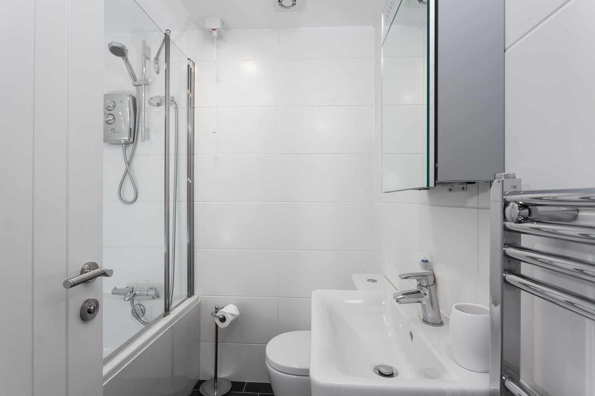 The family bathroom benefits from both a bath and shower, ideal for rinsing away the sand after a day on the beach!