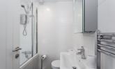 The family bathroom benefits from both a bath and shower, ideal for rinsing away the sand after a day on the beach! - Thumbnail Image