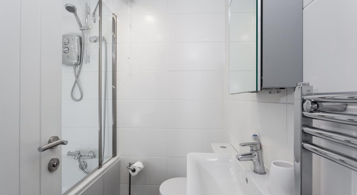 The family bathroom benefits from both a bath and shower, ideal for rinsing away the sand after a day on the beach!