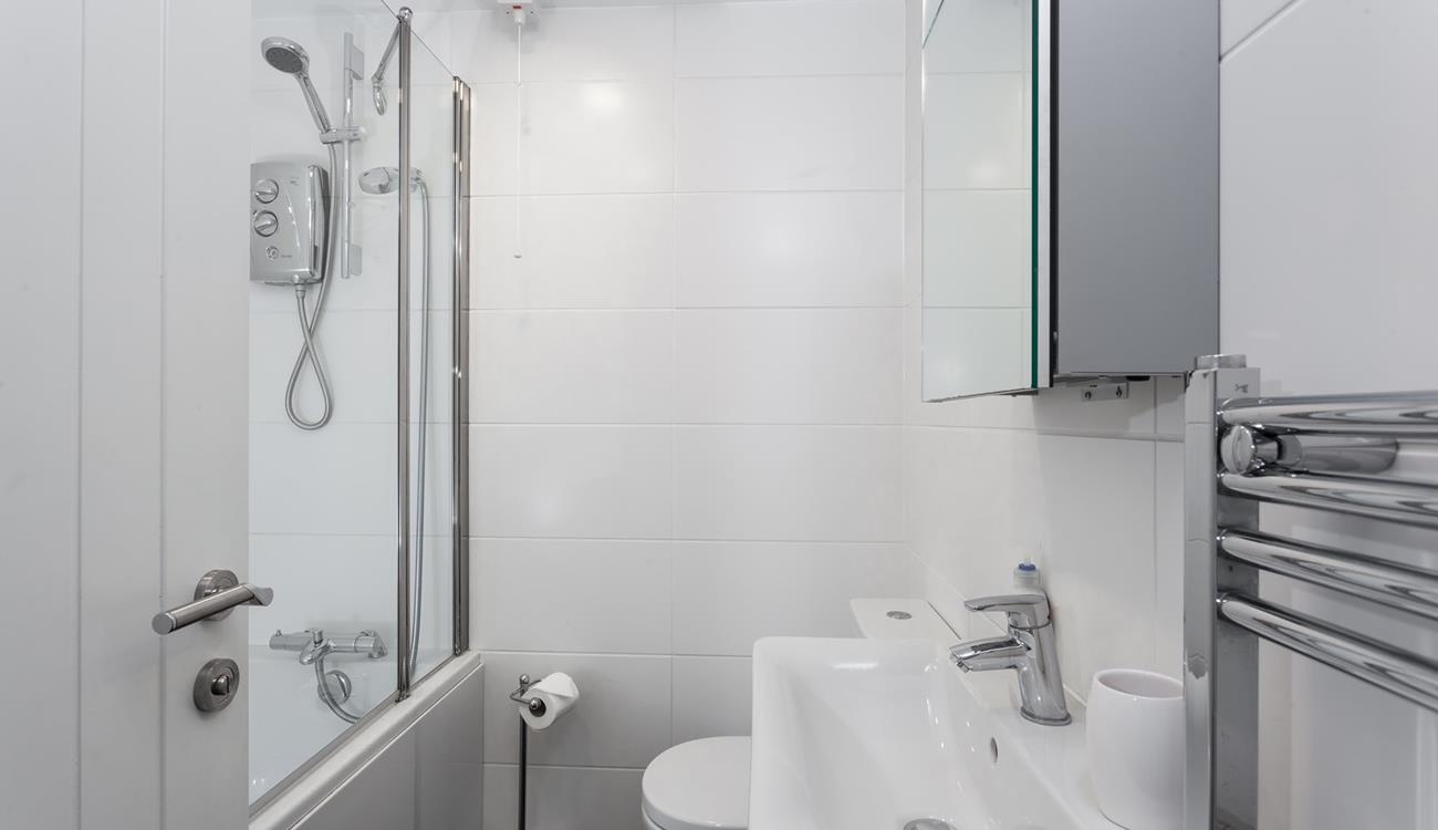 The family bathroom benefits from both a bath and shower, ideal for rinsing away the sand after a day on the beach!