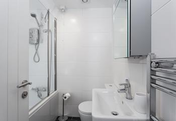The family bathroom benefits from both a bath and shower, ideal for rinsing away the sand after a day on the beach!