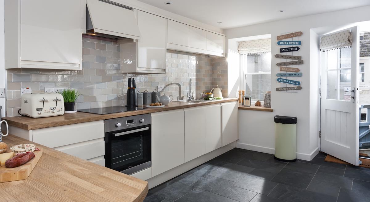 The kitchen is beautifully decorated in neutral tones and is fabulously well-equipped with modern appliances.