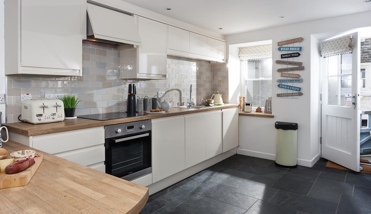 The kitchen is beautifully decorated in neutral tones and is fabulously well-equipped with modern appliances.