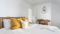 Minimalistic decor and soft tones help you to unwind before bed.
