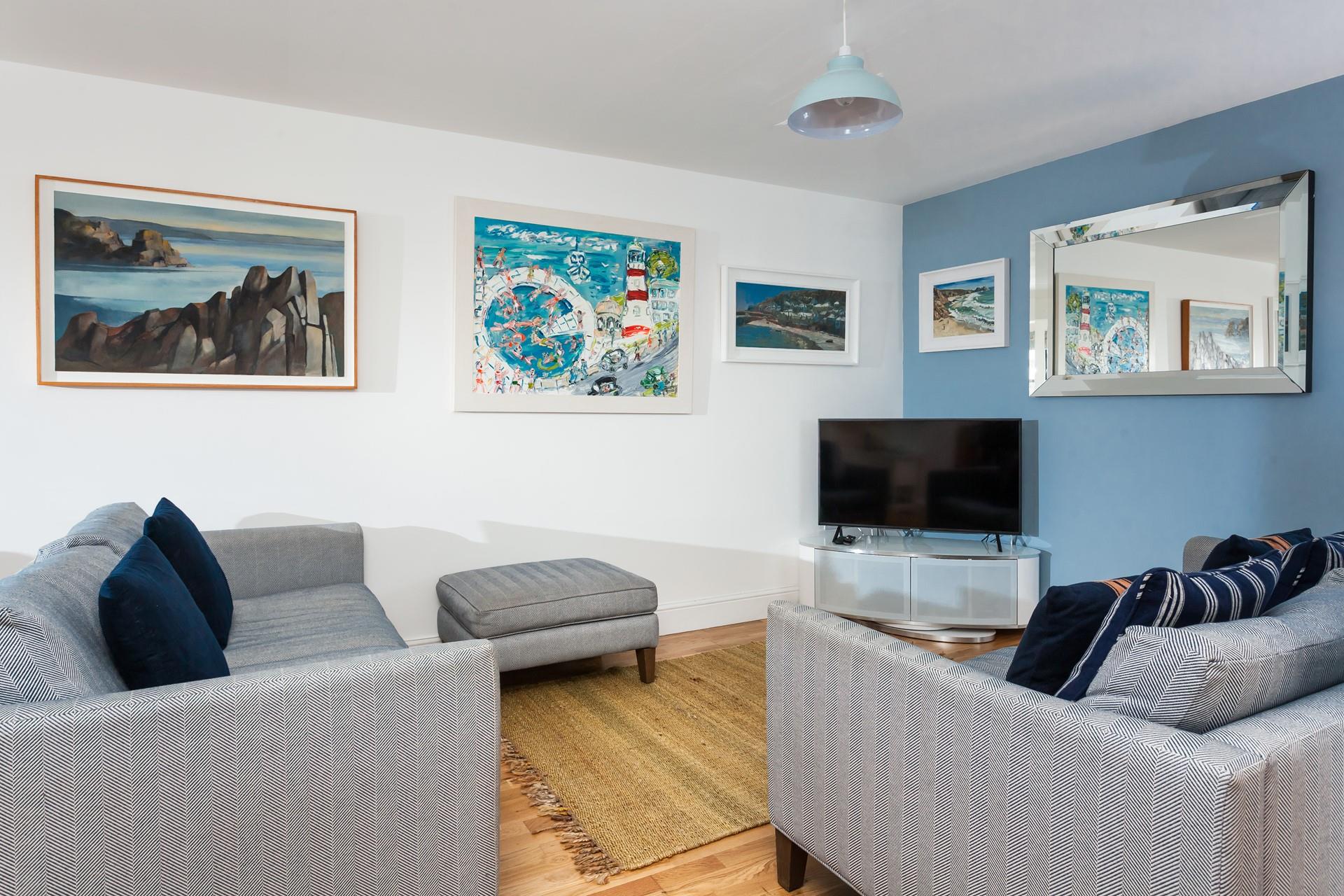 Coastal-inspired artwork fills the walls of the cosy apartment.