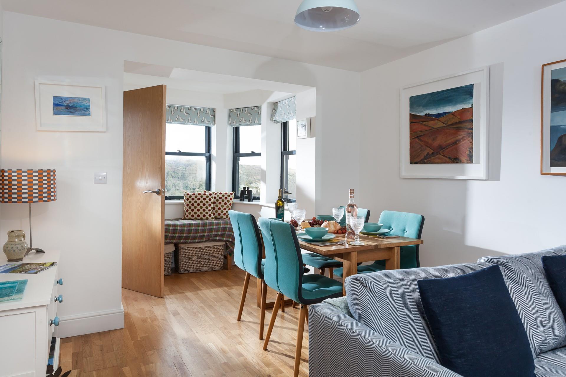 The open plan living/dining area has sea views from the window seat.