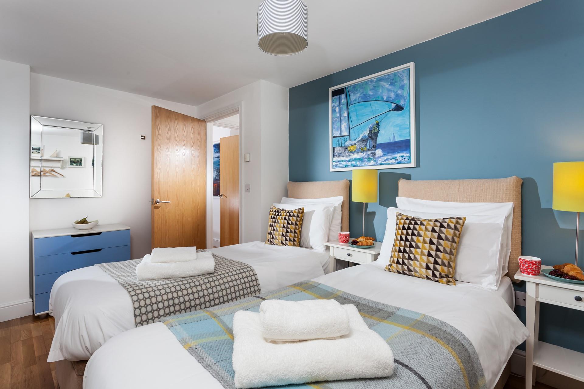 Settle the kids to sleep in the twin beds.