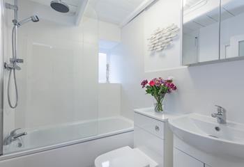The modern bathroom is located on the first floor and boasts both a bath and shower over.