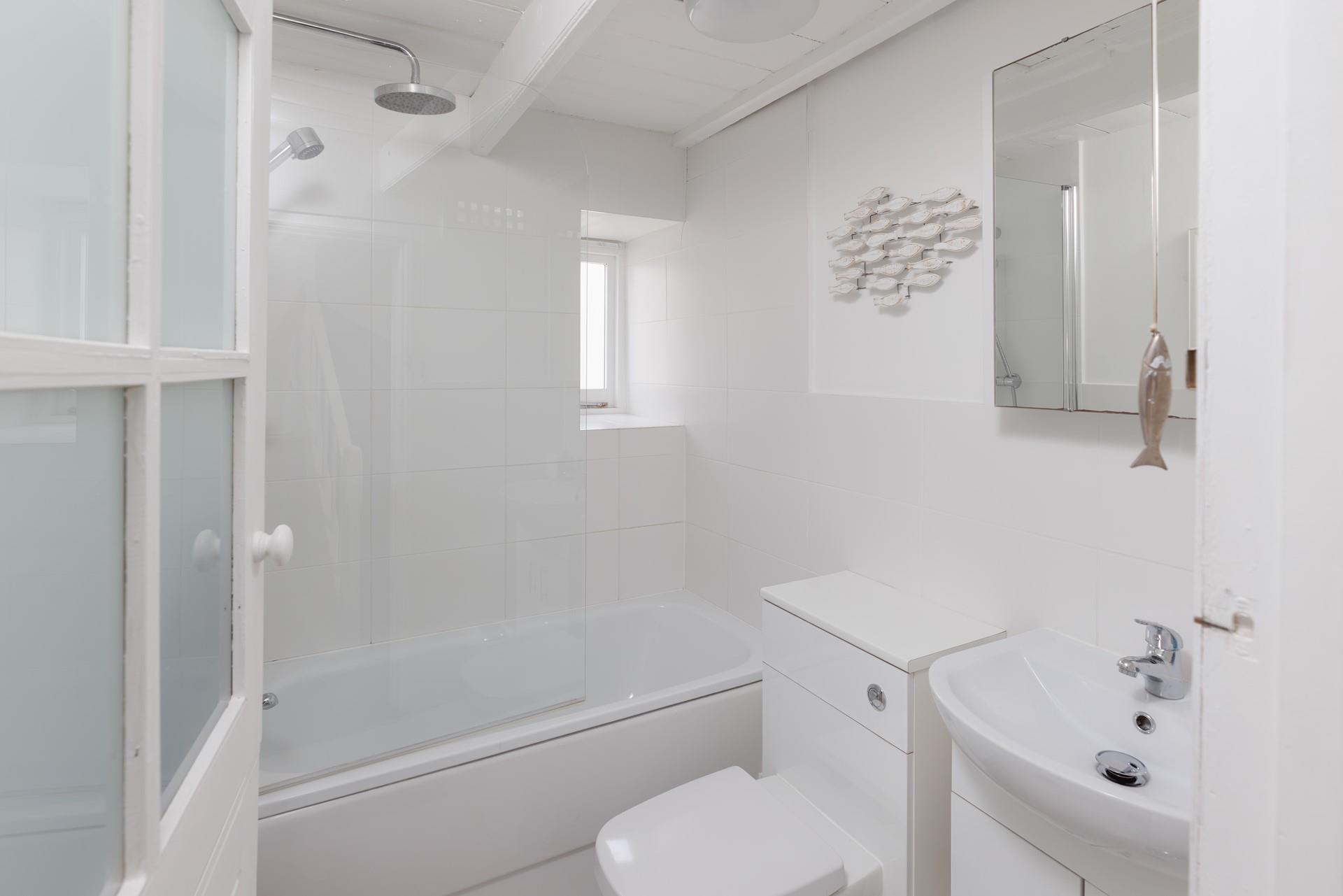 The modern bathroom is located on the first floor and boasts both a bath and a shower.