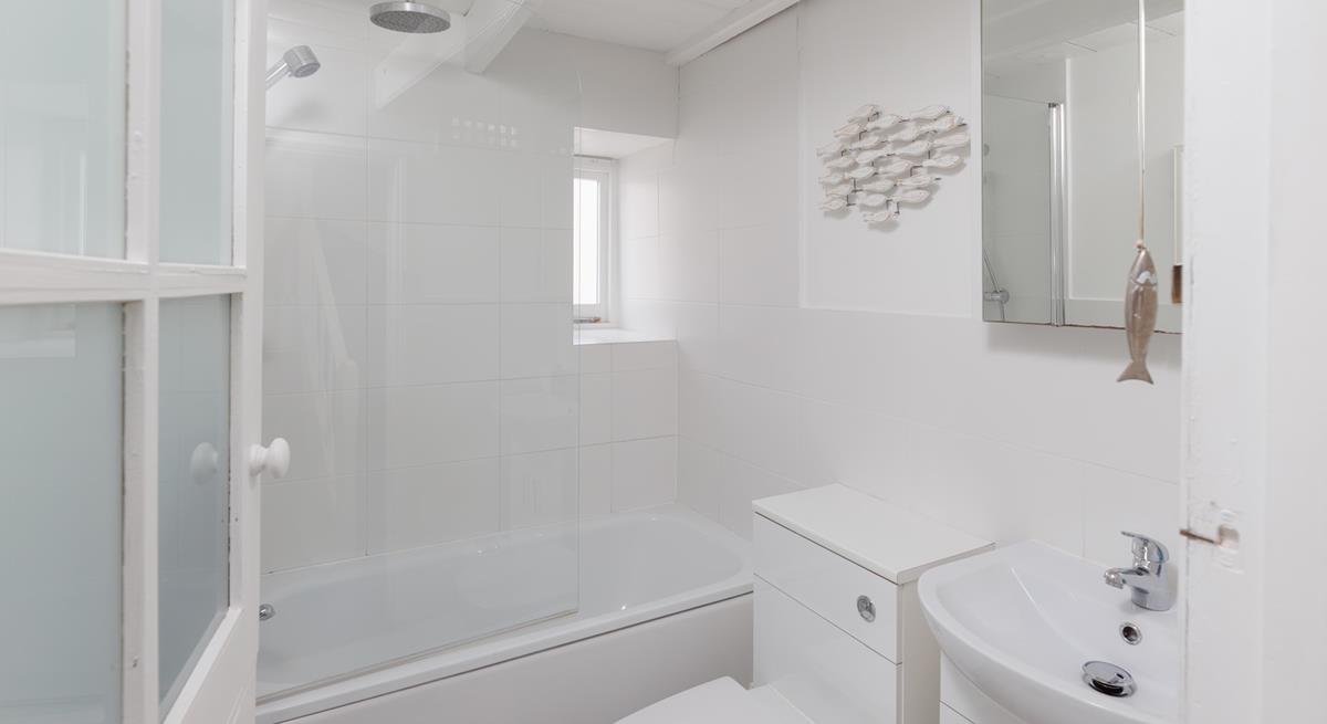 The modern bathroom is located on the first floor and boasts both a bath and a shower.