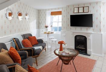 The adorable lounge area offers cosy seating and soothing tones, perfect for relaxing with a glass of something chilled.