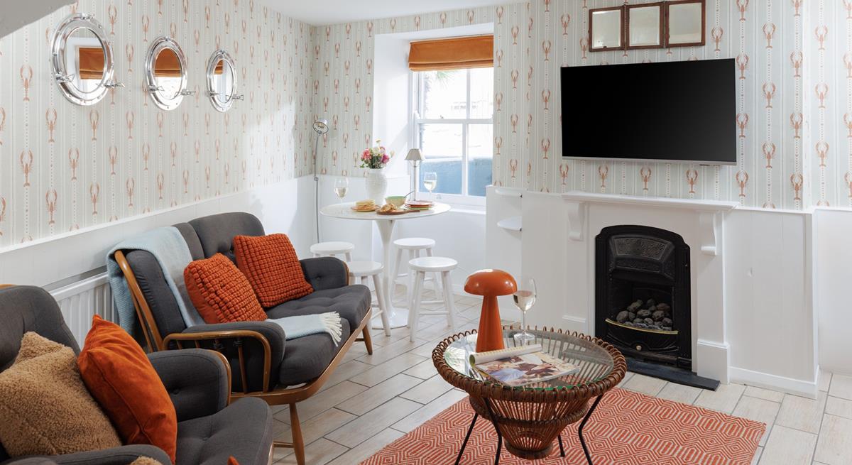 The adorable lounge area offers cosy seating and soothing tones, perfect for relaxing with a glass of something chilled.